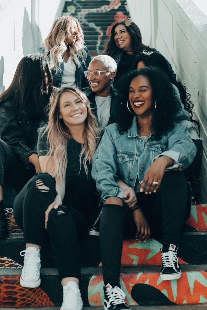 A group of friends laughing together on outdoor steps