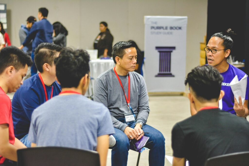 A group of people sitting in a circle in conversation