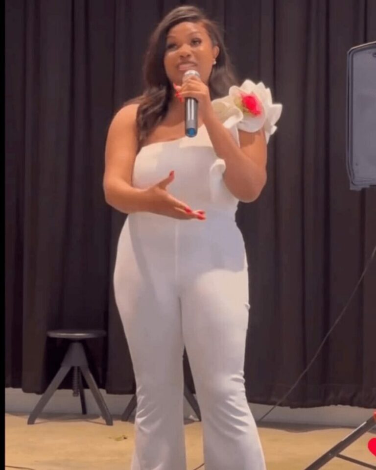 Shamica speaking on stage with a microphone