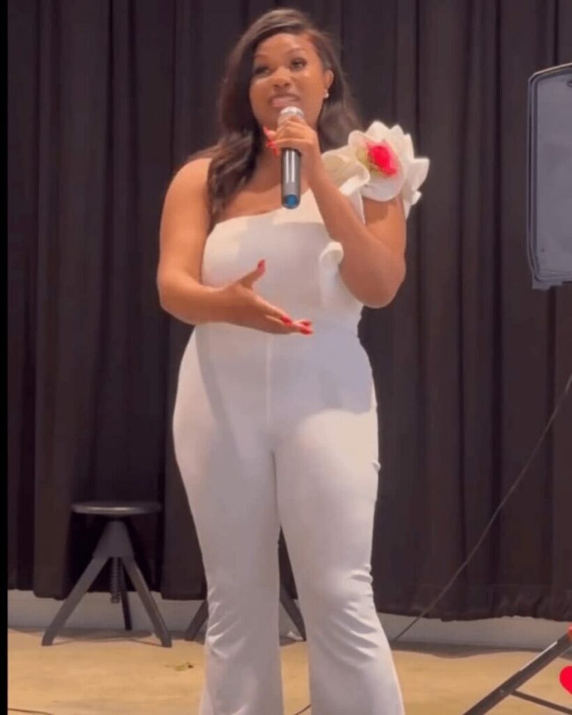 Shamica speaking on stage with a microphone