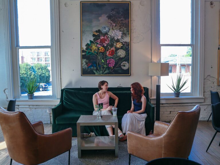 Two women in conversation in a bright lounge