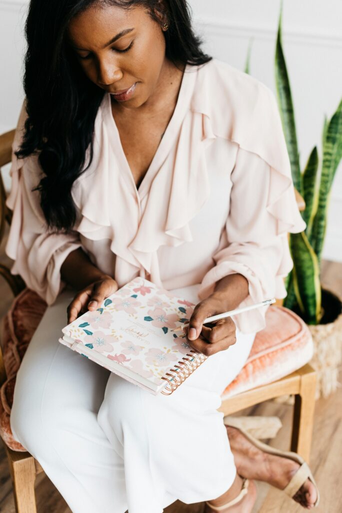A woman writing in a journal at home
